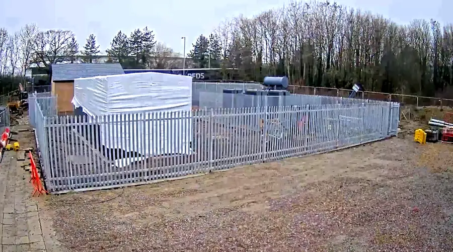Completed ground-mounted substation enclosed within palisade security fencing